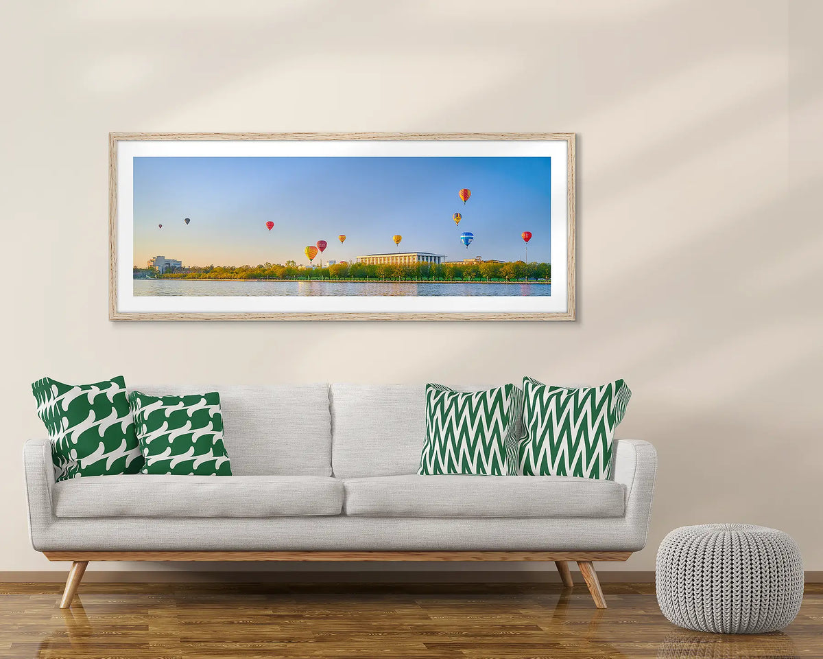 Upwards. Canberra balloon artwork framed in Tasmanian Oak, above a couch. 