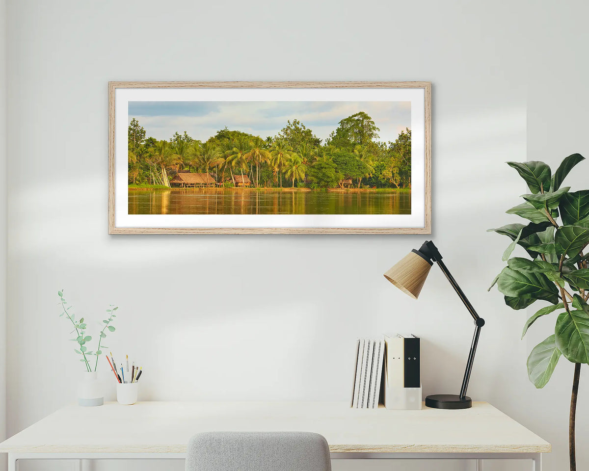 Village Life. Papua New Guinea wall art print with a timber frame, hung above a home office desk. 