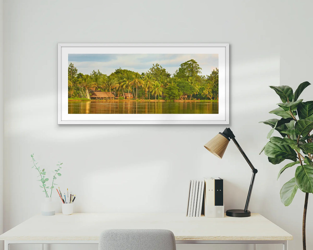 Village Life. Papua New Guinea wall art print with a white frame, hung above a home office desk. 