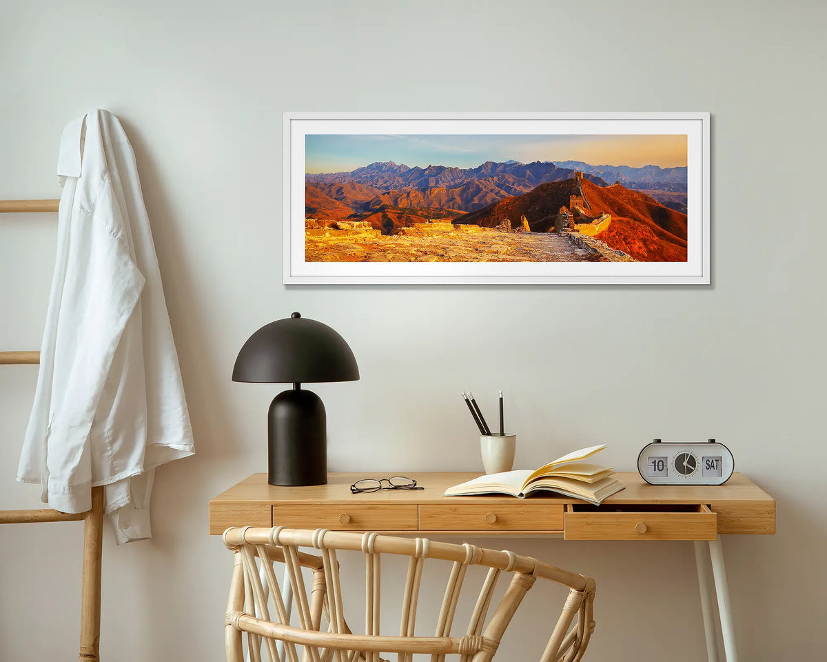 Wall Sunset. Great Wall of China wall art print with white frame above small desk.