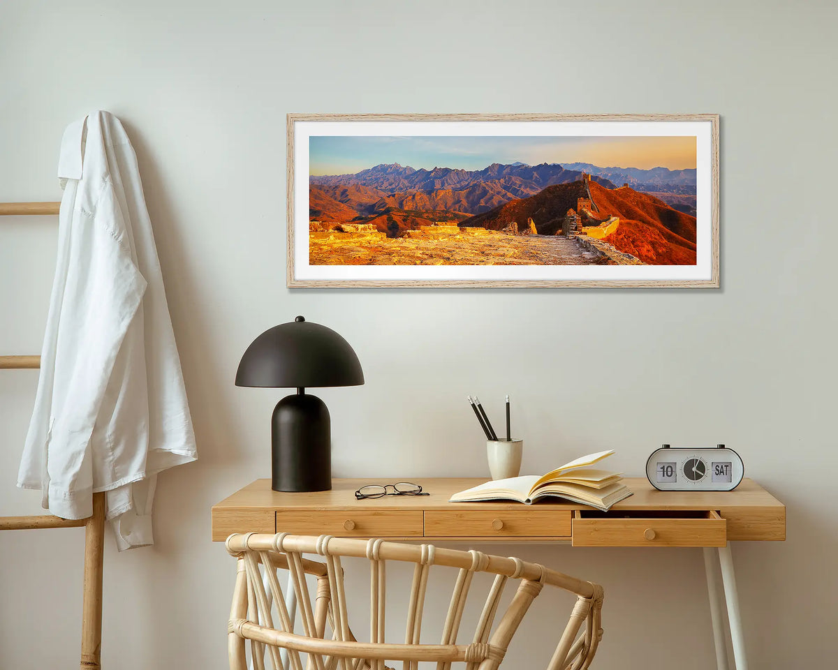 Wall Sunset. Great Wall of China wall art print with wood frame above small desk.