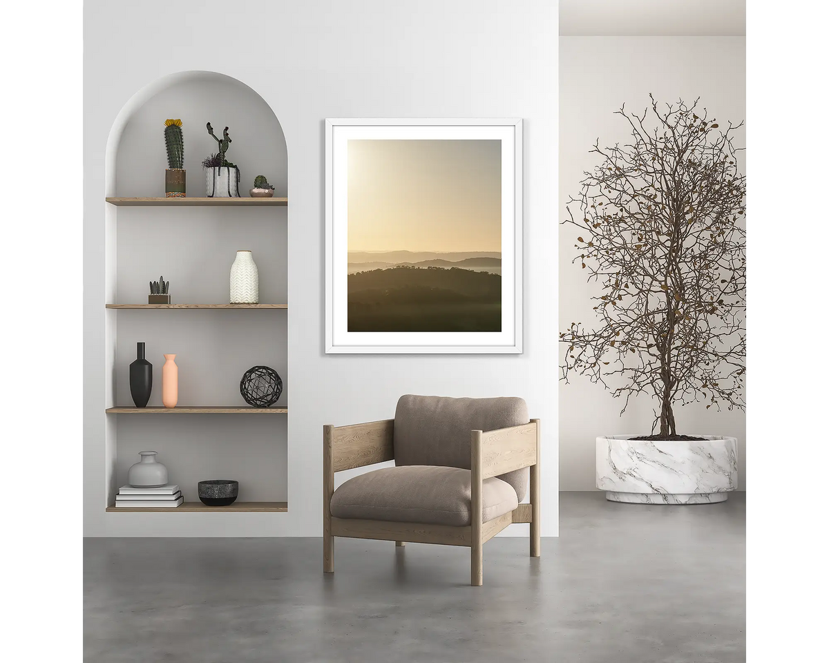 Wanniassa Wakes. Canberra sunrise wall art print, with a white frame, hung above a chair. 