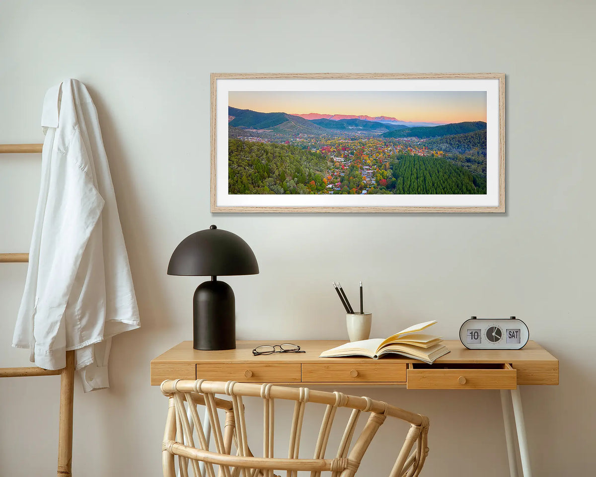 Welcome to Bright wall art print with wood frame hung above small desk.