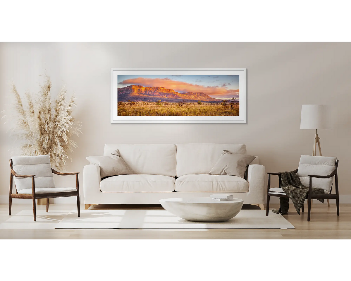 Wilpena Waking. Flinders Ranges wall art in a white frame above a couch. 