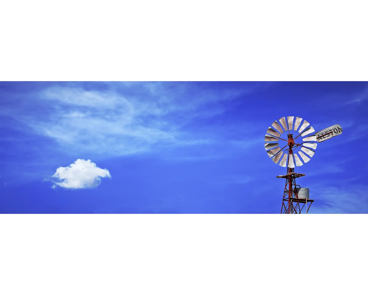 An old farm windmill against a backdrop of blue sky, Rochester, Victoria. 