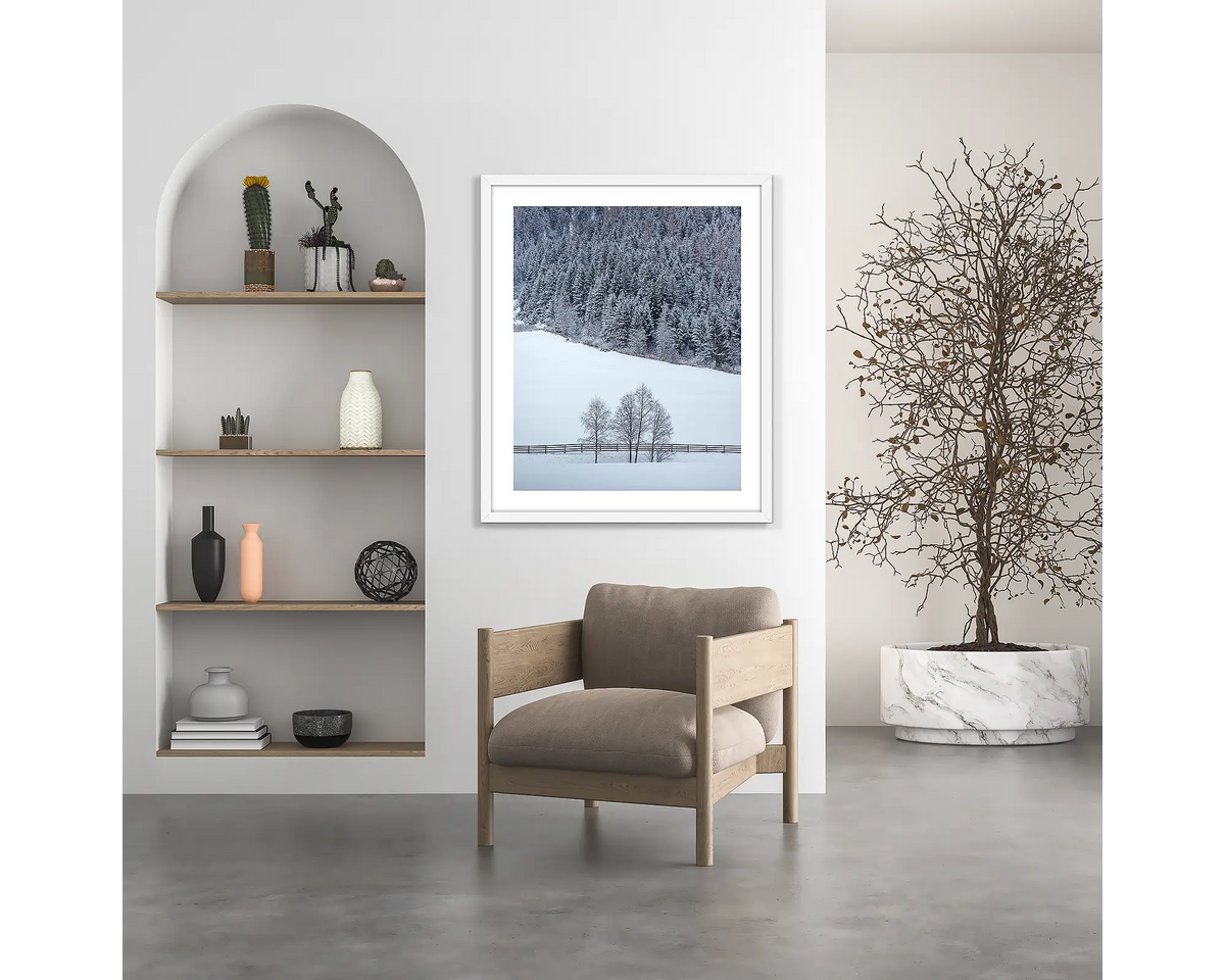 Winter Discovery. Austria wall art print, with a white frame, hung above a chair. 