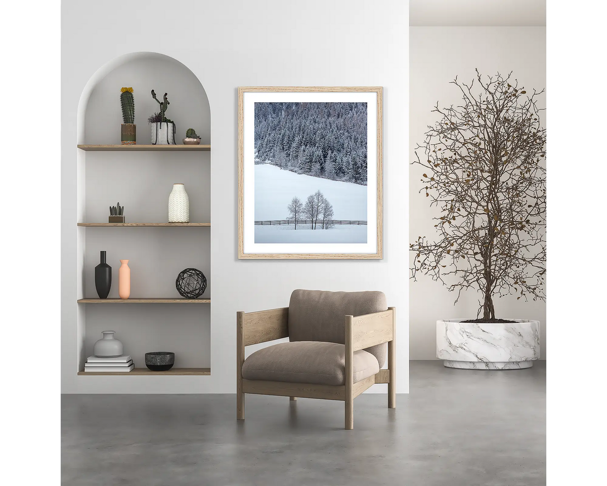 Winter Discovery. Austria wall art print, with a wood frame, hung above a chair.