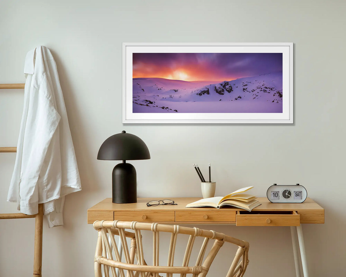 Winter Magic. Blue Lake in winter wall art print with white frame hung above small desk.