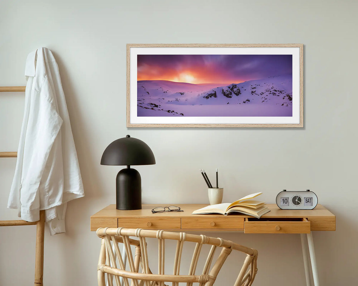 Winter Magic. Blue Lake in winter wall art print with wood frame hung above small desk.