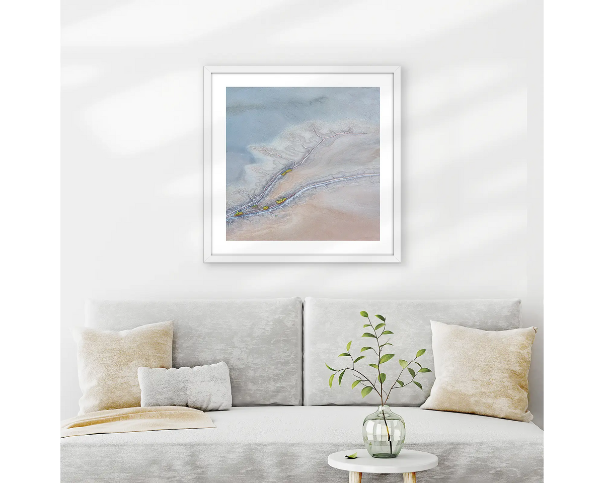 Withdraw. Abstract patterns wall art print with white frame hung above couch.