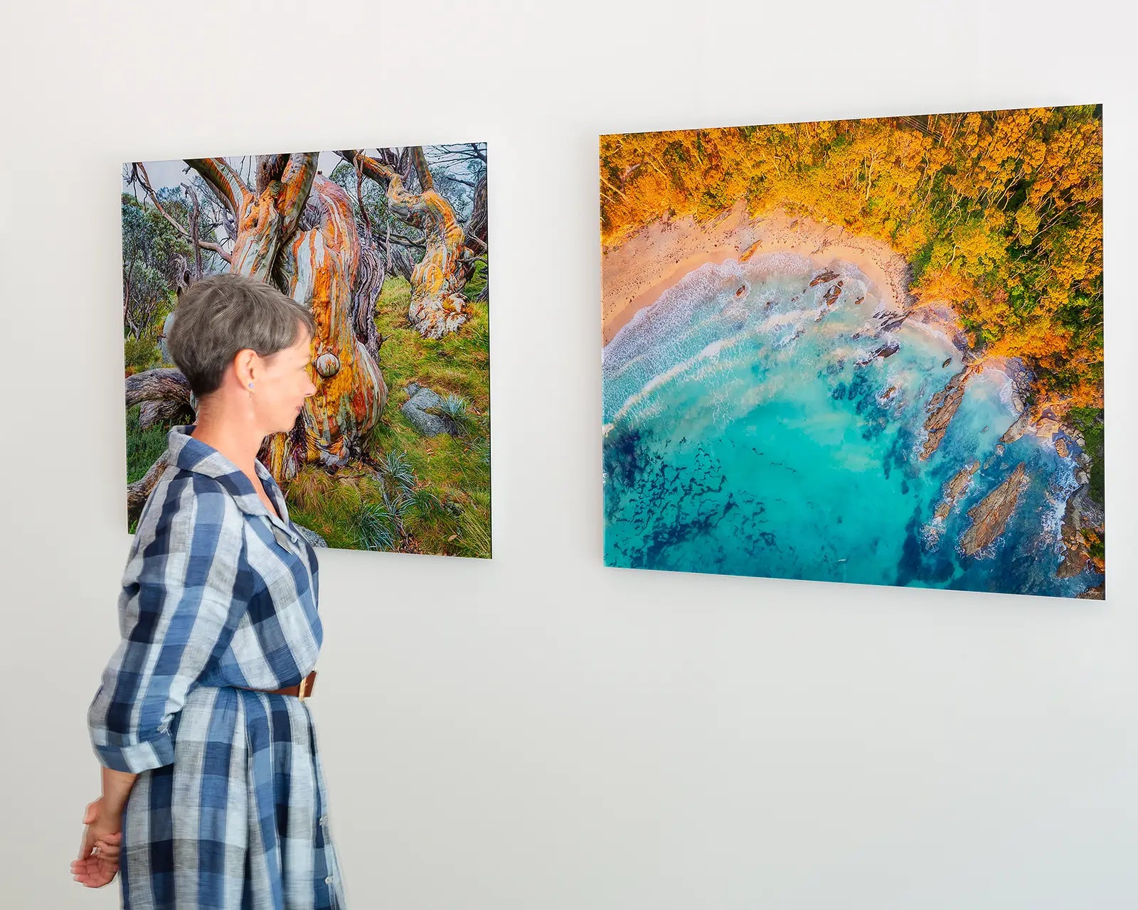 Women looking at frameless acrylic wall art prints.