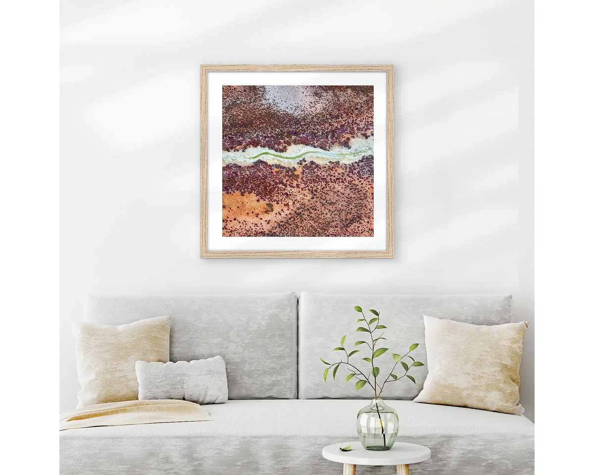 Wriggle. Abstract Kimberley wall art print with wood frame hung above couch.