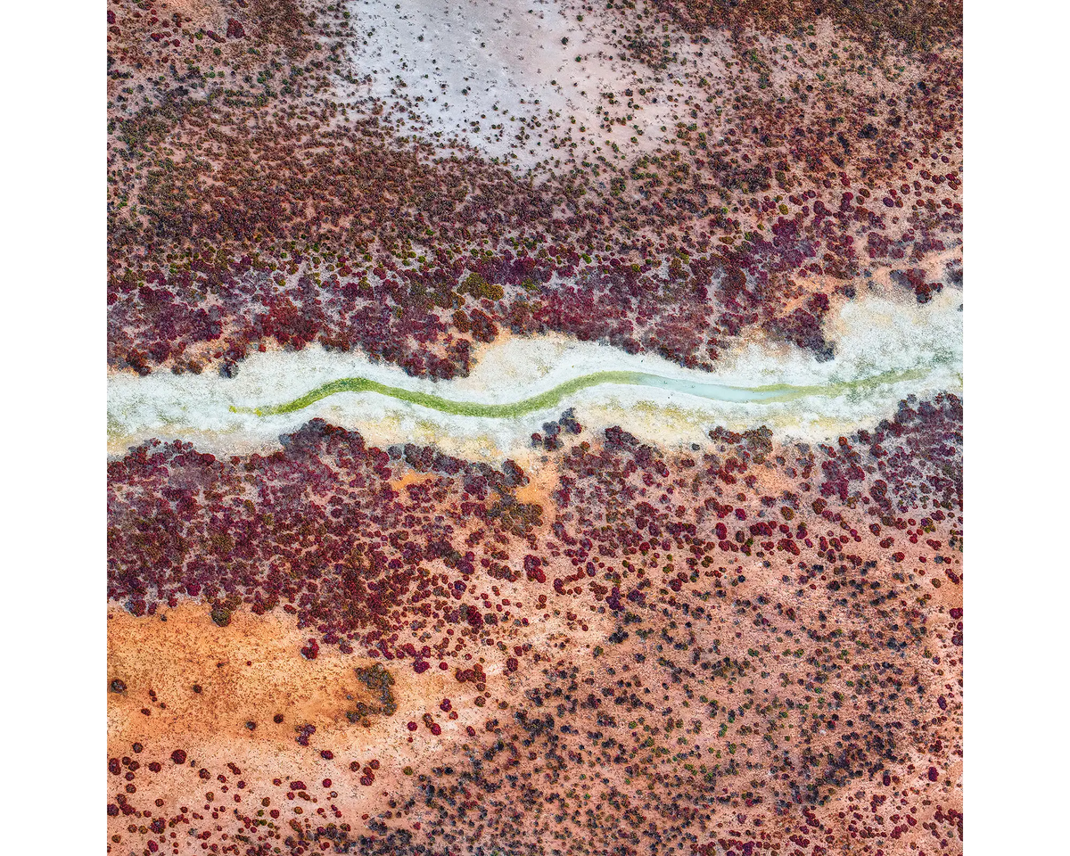 Aerial view of colourful purple and orange patterns in Roebuck Plains, the Kimberley, WA. 