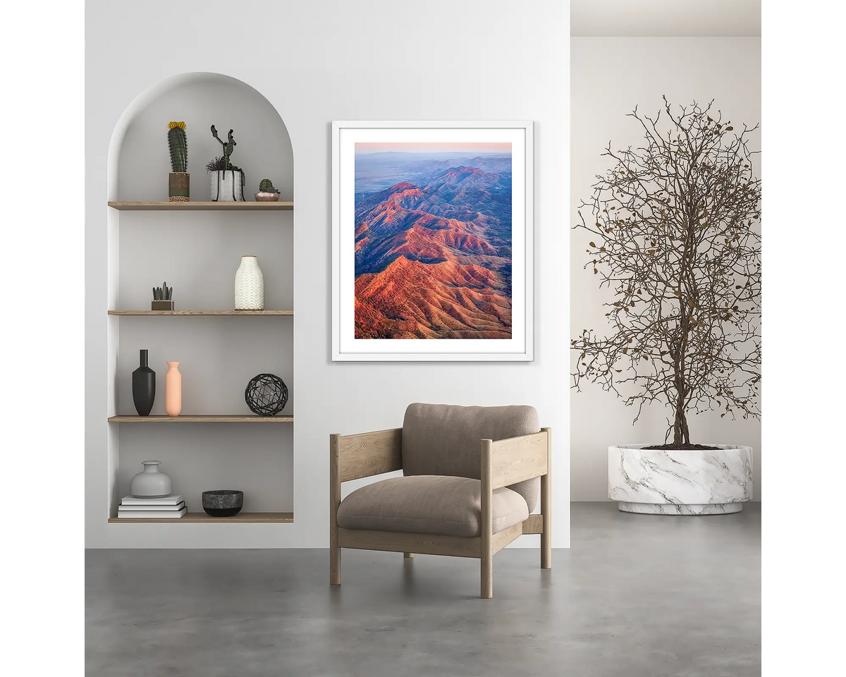 Wrinkles. Flinders Ranges wall art print, with a white frame, hung above a chair.