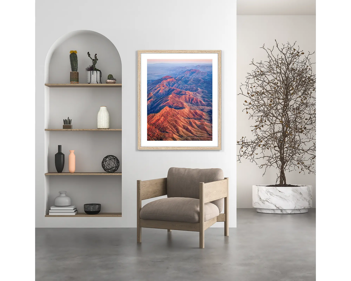 Wrinkles. Flinders Ranges wall art print, with a wood frame, hung above a chair.