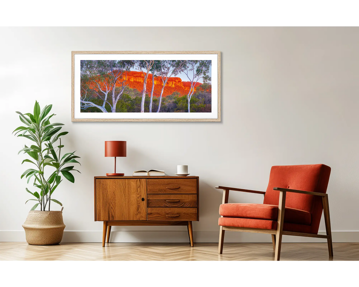 Young and Old. Framed Blue Mountains  wall art on a wall, above a side table. 