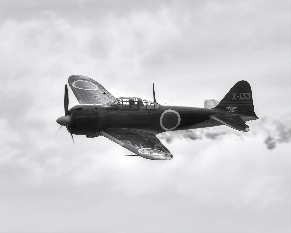Mitsubishi A6M Zero &#39;X-133&#39; restored World War II fighter aircraft flying through cloud. 